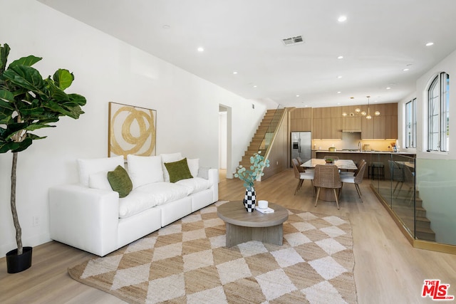 living room featuring light hardwood / wood-style floors and sink