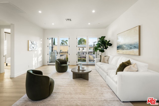 living room with french doors and light hardwood / wood-style floors