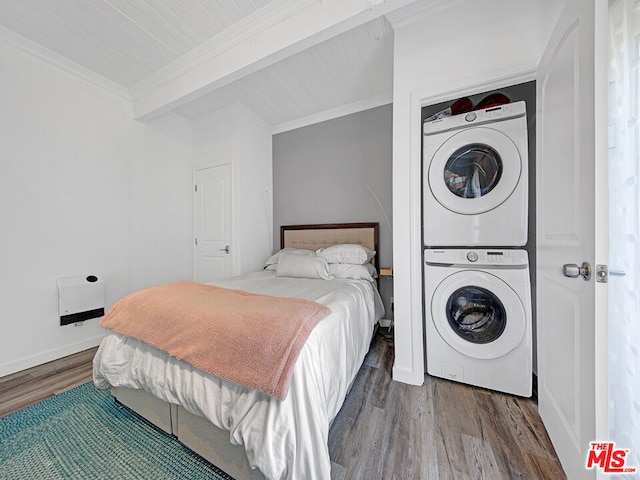 bedroom featuring hardwood / wood-style flooring, beam ceiling, crown molding, and stacked washer and clothes dryer