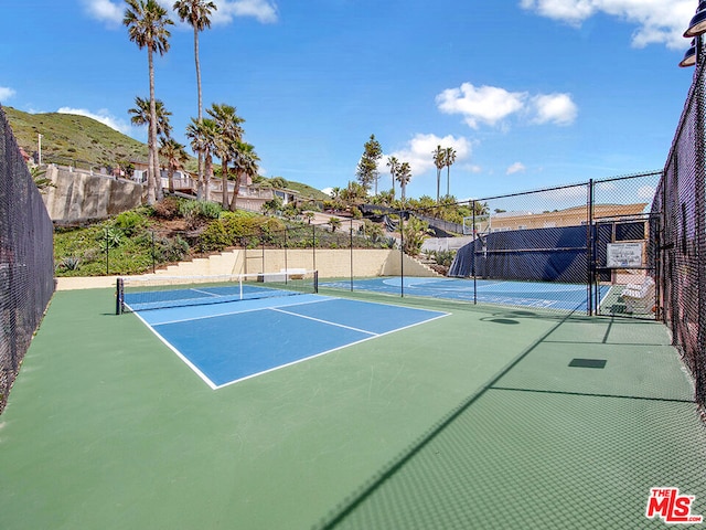 view of sport court with a mountain view and basketball court