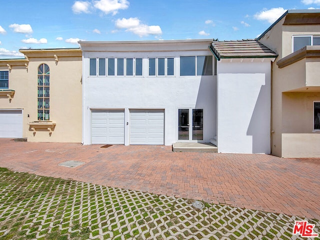 view of front facade with a garage and french doors