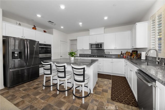 kitchen with white cabinetry, sink, a center island, and black appliances