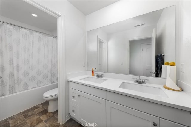 full bathroom featuring toilet, vanity, and shower / tub combo