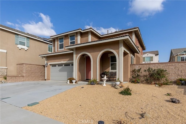 mediterranean / spanish-style home with a garage