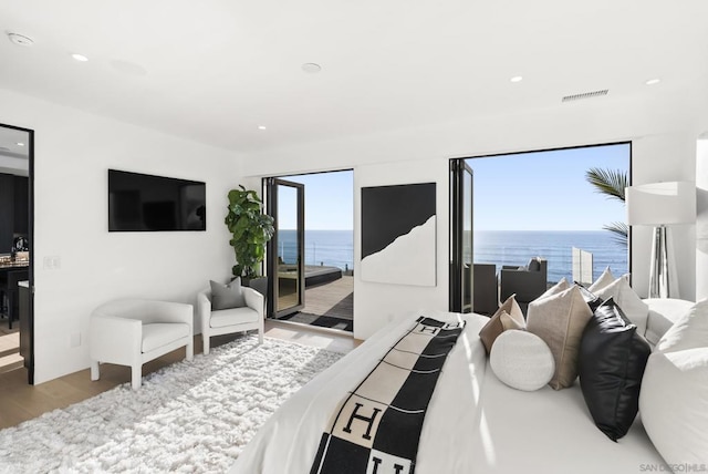 bedroom featuring light hardwood / wood-style floors and access to outside