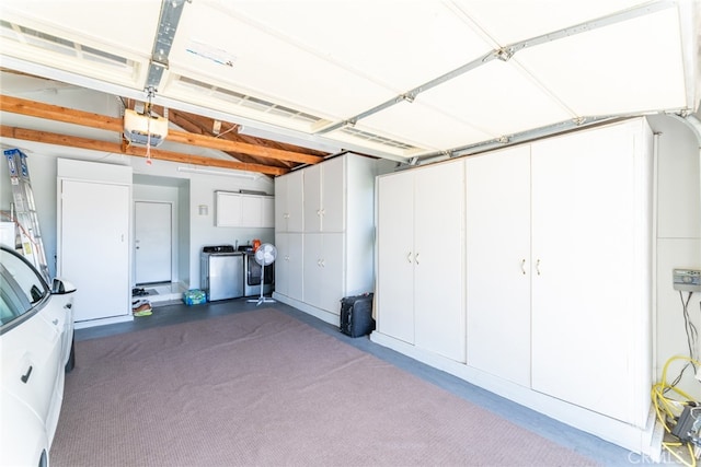 garage featuring washing machine and dryer and a garage door opener