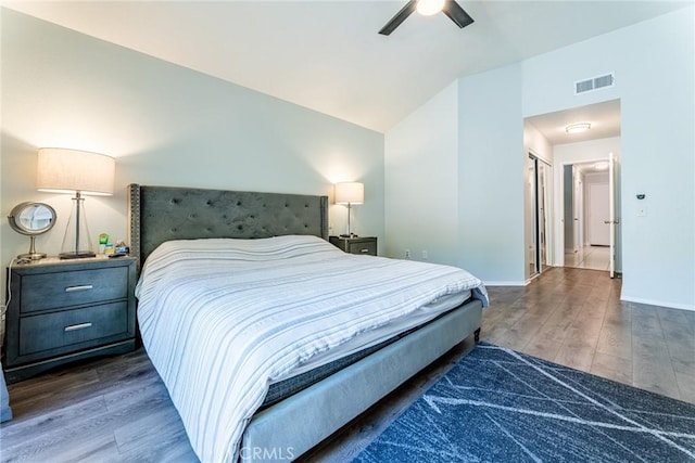 bedroom with lofted ceiling, ceiling fan, and dark wood-type flooring