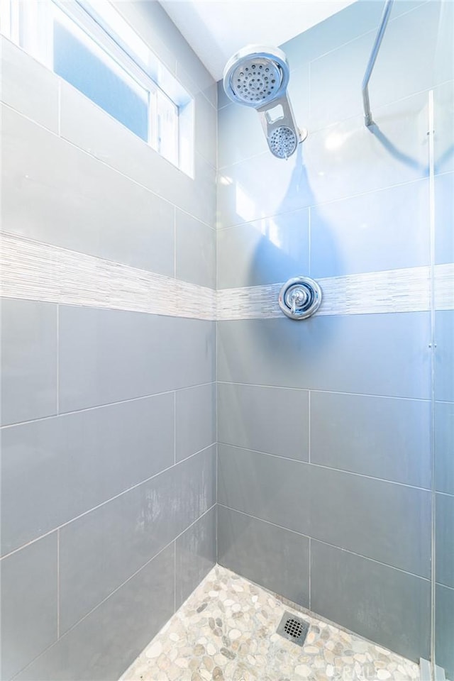 bathroom with tiled shower