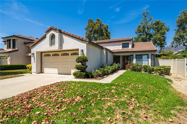 view of front of home featuring a front yard and a garage