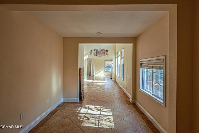 hall featuring light tile patterned flooring