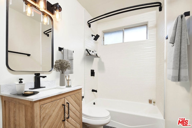 full bathroom with vanity, tiled shower / bath combo, and toilet