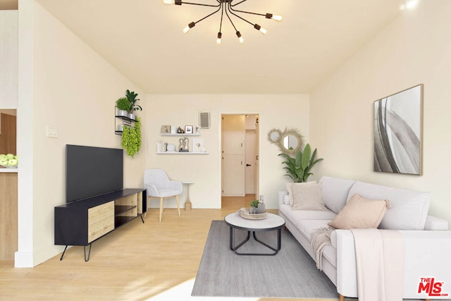 living room featuring hardwood / wood-style flooring and an inviting chandelier