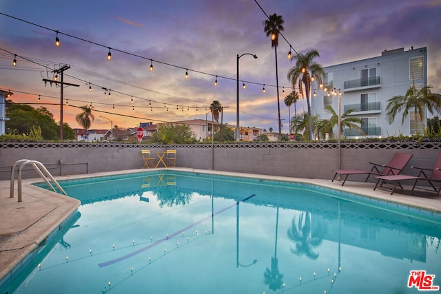 view of pool at dusk