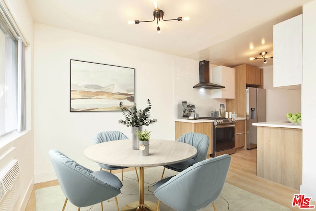 dining area featuring light hardwood / wood-style floors and a wall mounted AC