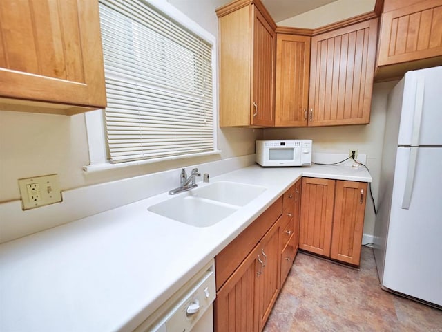 kitchen with white appliances and sink