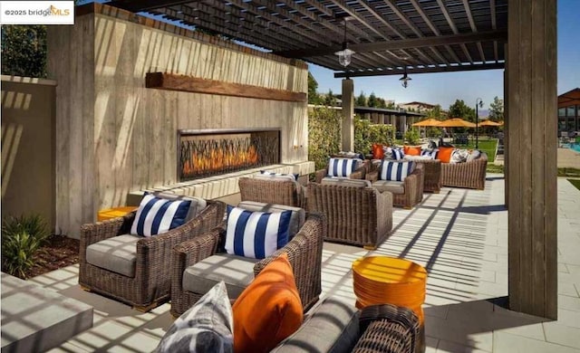 view of patio / terrace featuring an outdoor living space with a fireplace and a pergola