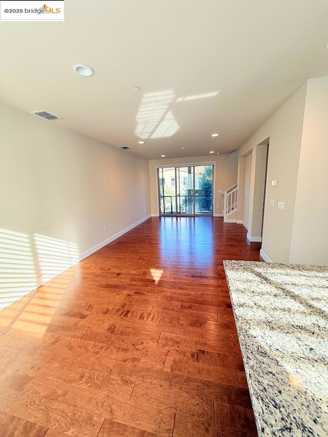 unfurnished room featuring hardwood / wood-style flooring