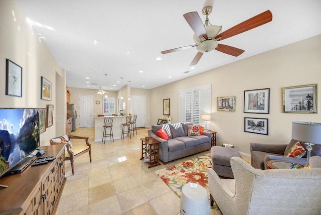 living room featuring ceiling fan and light tile patterned floors