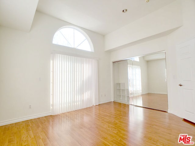 unfurnished room with a wealth of natural light and wood-type flooring