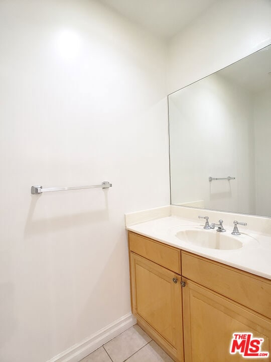 bathroom featuring tile patterned flooring and vanity