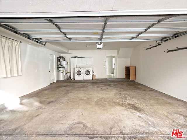 garage with a garage door opener and washing machine and clothes dryer