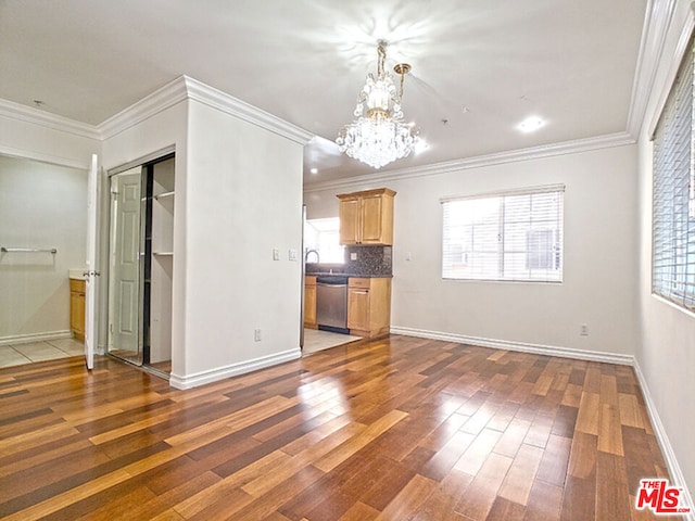 unfurnished living room featuring ornamental molding, dark hardwood / wood-style flooring, and a notable chandelier