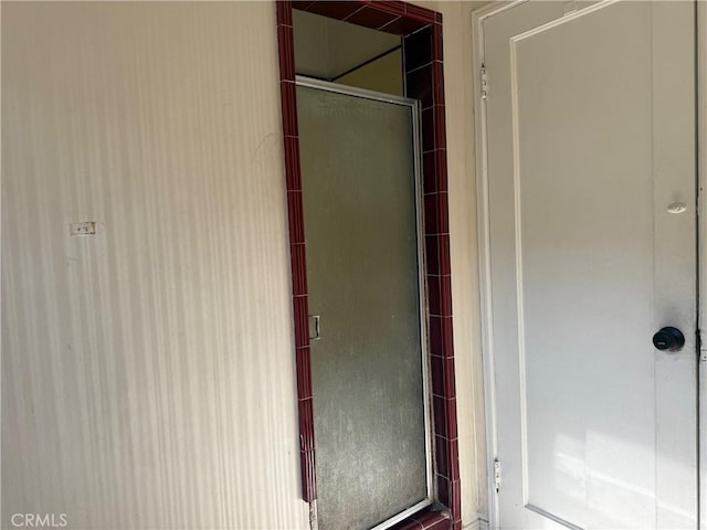 bathroom featuring a shower with shower door