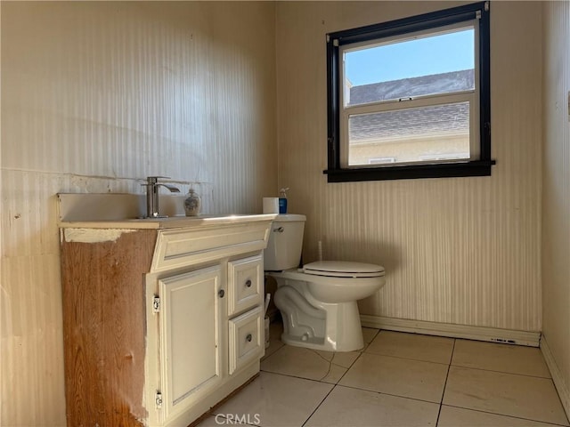 bathroom featuring toilet, vanity, and tile patterned flooring