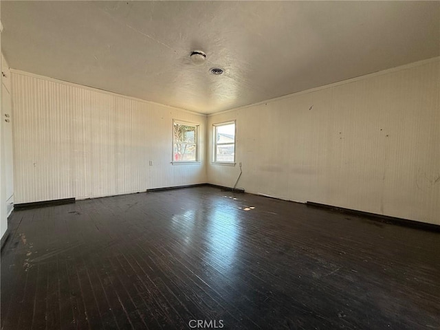 empty room with dark hardwood / wood-style flooring