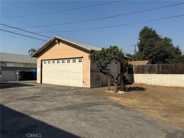 view of front of home with a garage and an outdoor structure