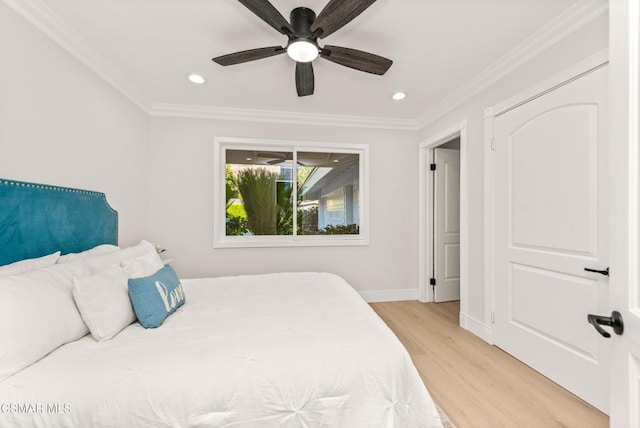 bedroom with crown molding, ceiling fan, and light wood-type flooring