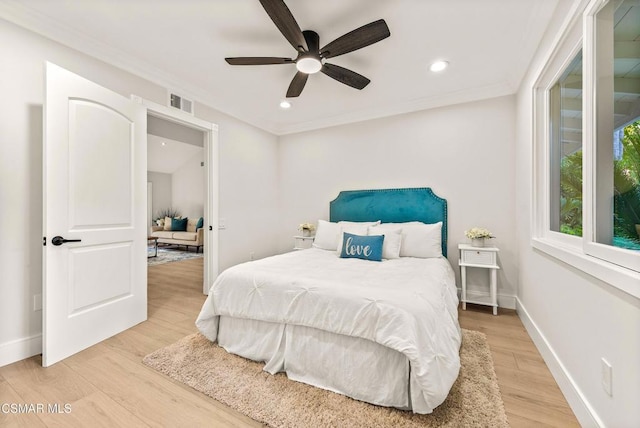 bedroom featuring light hardwood / wood-style flooring, ornamental molding, and ceiling fan