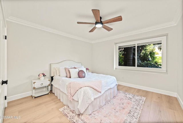 bedroom featuring light hardwood / wood-style flooring, ornamental molding, and ceiling fan