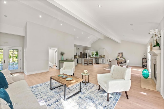 living room featuring high vaulted ceiling, light hardwood / wood-style floors, french doors, and beamed ceiling