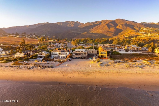 mountain view featuring a water view and a beach view