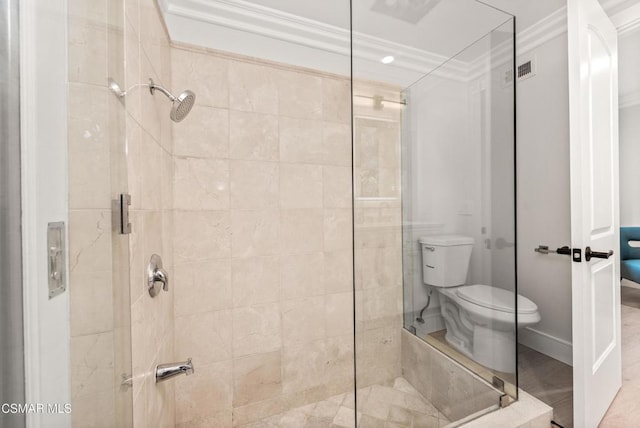 bathroom featuring ornamental molding, toilet, and an enclosed shower