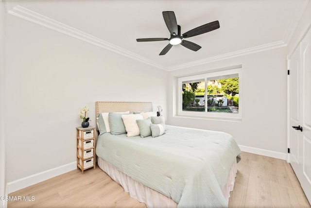 bedroom with crown molding, light hardwood / wood-style flooring, and ceiling fan