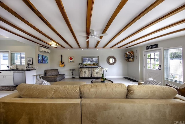 living room with plenty of natural light, ceiling fan, an AC wall unit, and sink