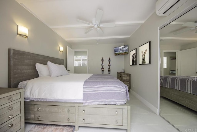 tiled bedroom with ceiling fan, a closet, beamed ceiling, and a wall mounted air conditioner