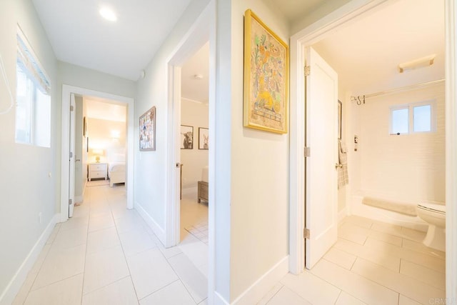 corridor with light tile patterned flooring