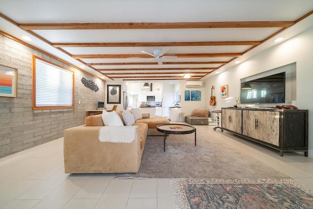 living room with beam ceiling, light tile patterned flooring, a wall unit AC, and brick wall