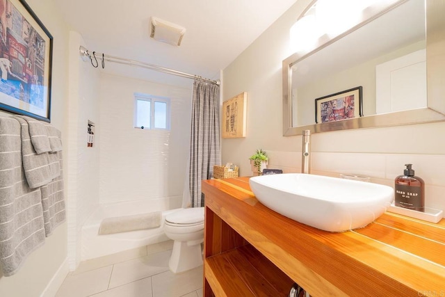 full bathroom with vanity, shower / tub combo with curtain, tile patterned floors, and toilet