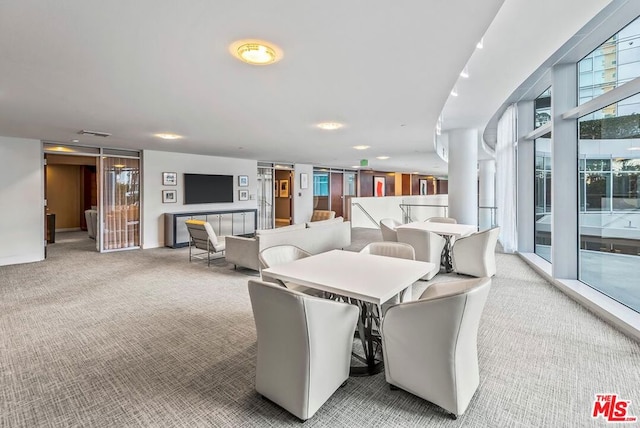 carpeted dining room featuring plenty of natural light