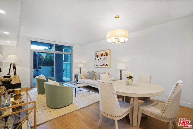 dining room with hardwood / wood-style flooring and expansive windows