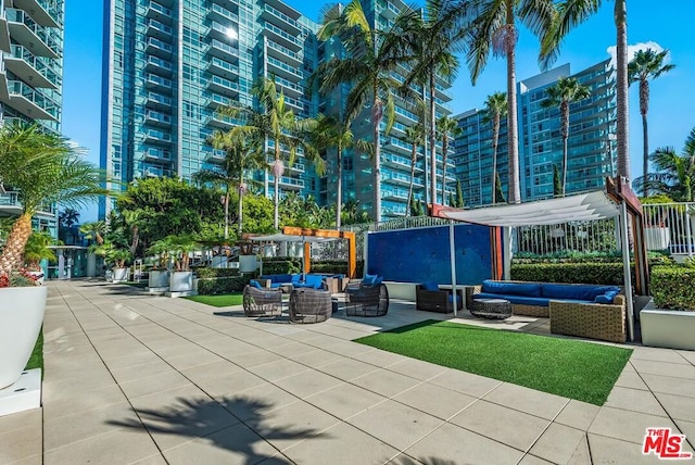 view of property's community featuring outdoor lounge area and a patio area