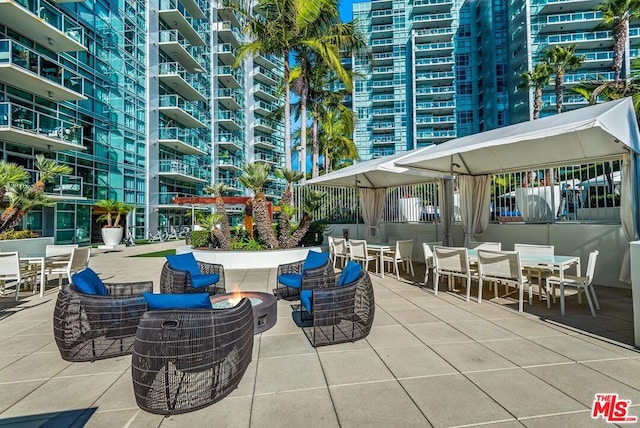 view of patio / terrace with an outdoor fire pit