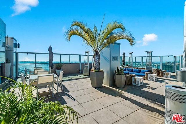 view of patio featuring an outdoor living space, a water view, and central AC unit