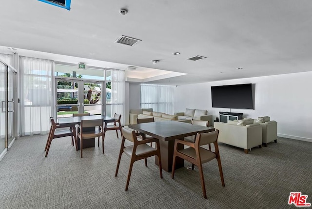 carpeted dining room with french doors