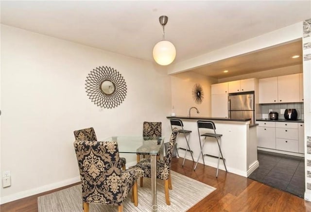 dining space featuring dark hardwood / wood-style floors