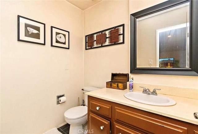 bathroom featuring tile patterned floors, vanity, and toilet